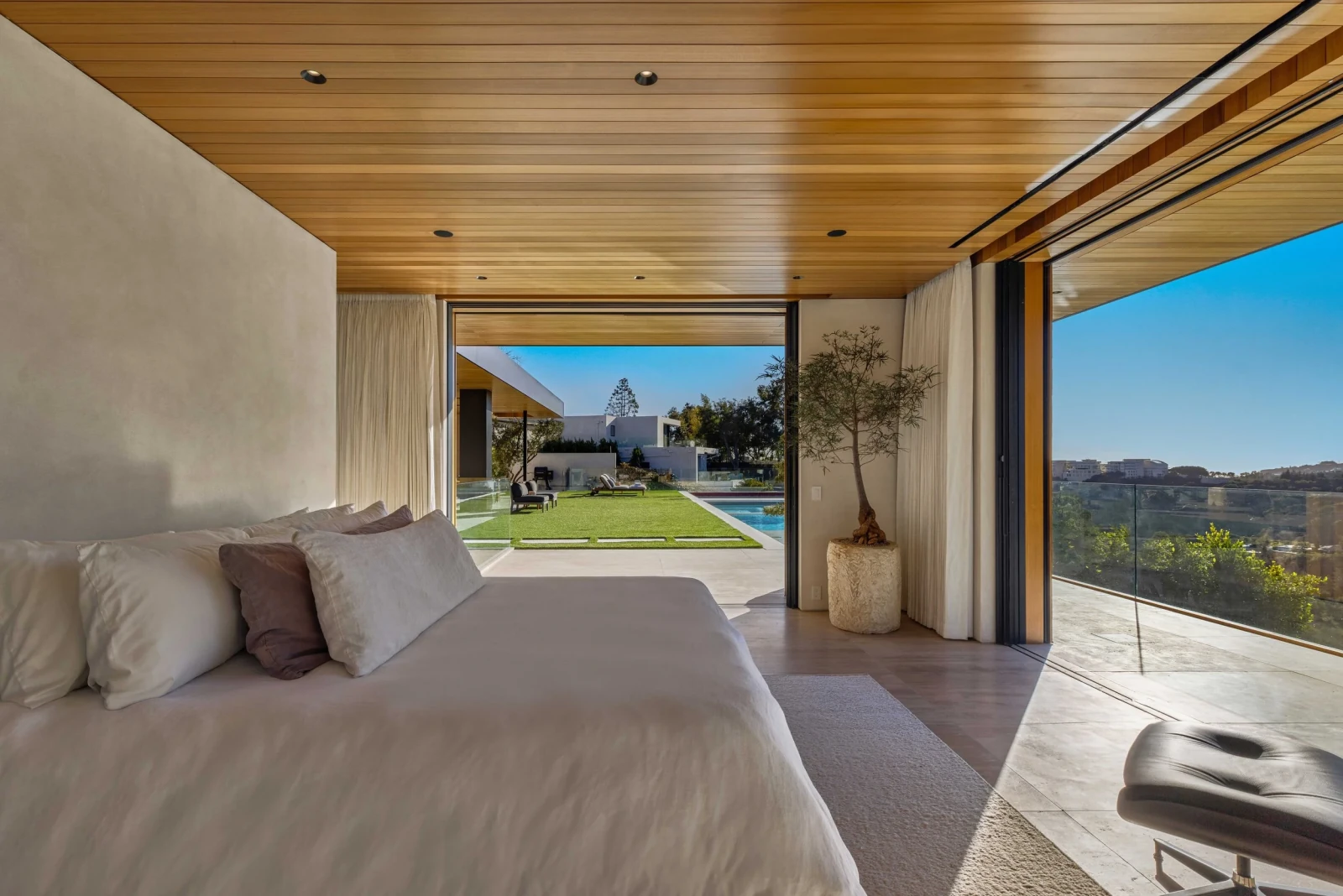 TITONI minimal-frame aluminum sliding system opening to a pool terrace